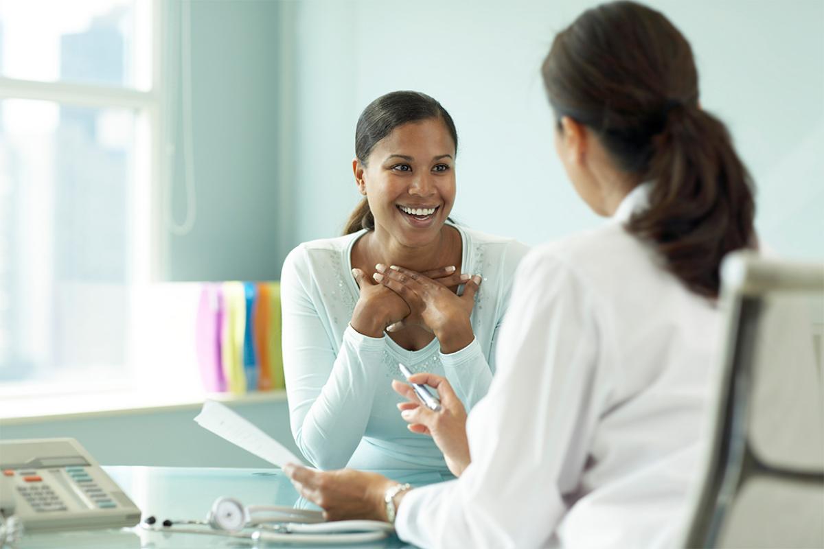 Smiling patient speaking with physician