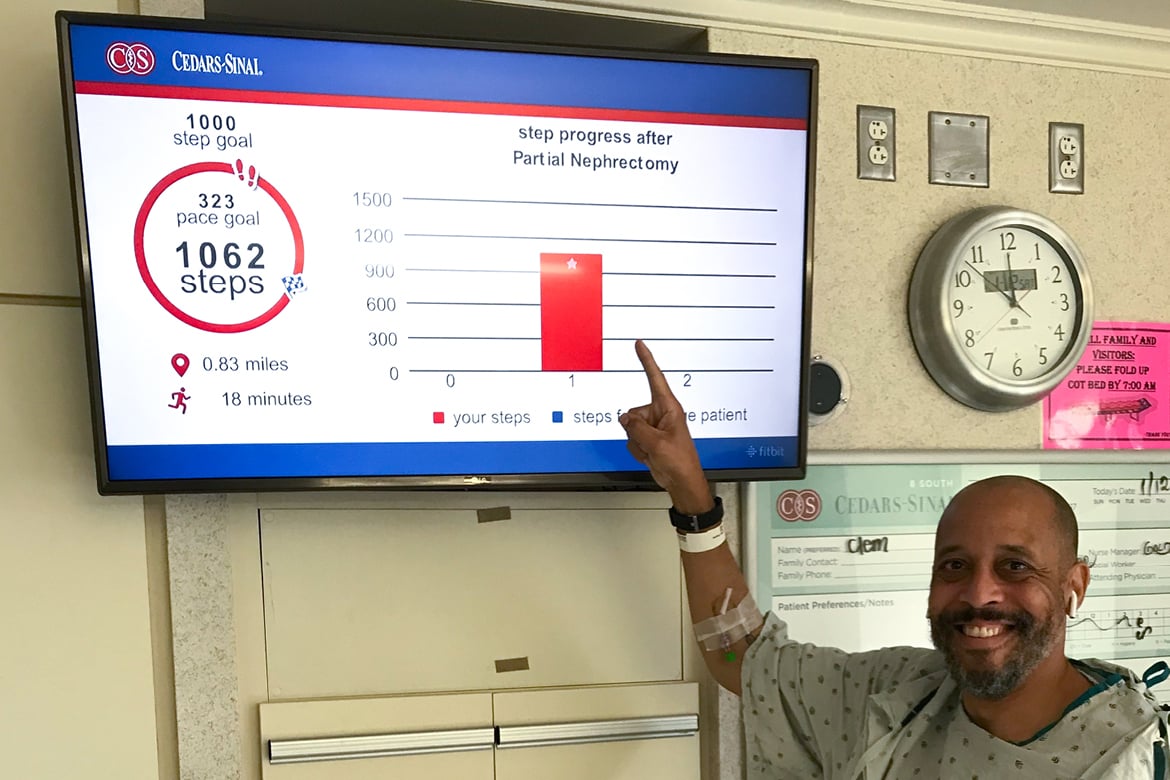 Patient pointing at his steps progress on a screen