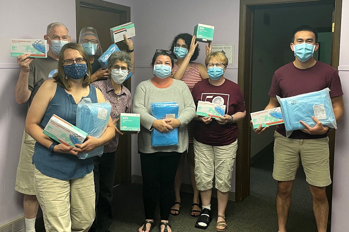 The Iowa City Free Medical Clinic employees holding PPE