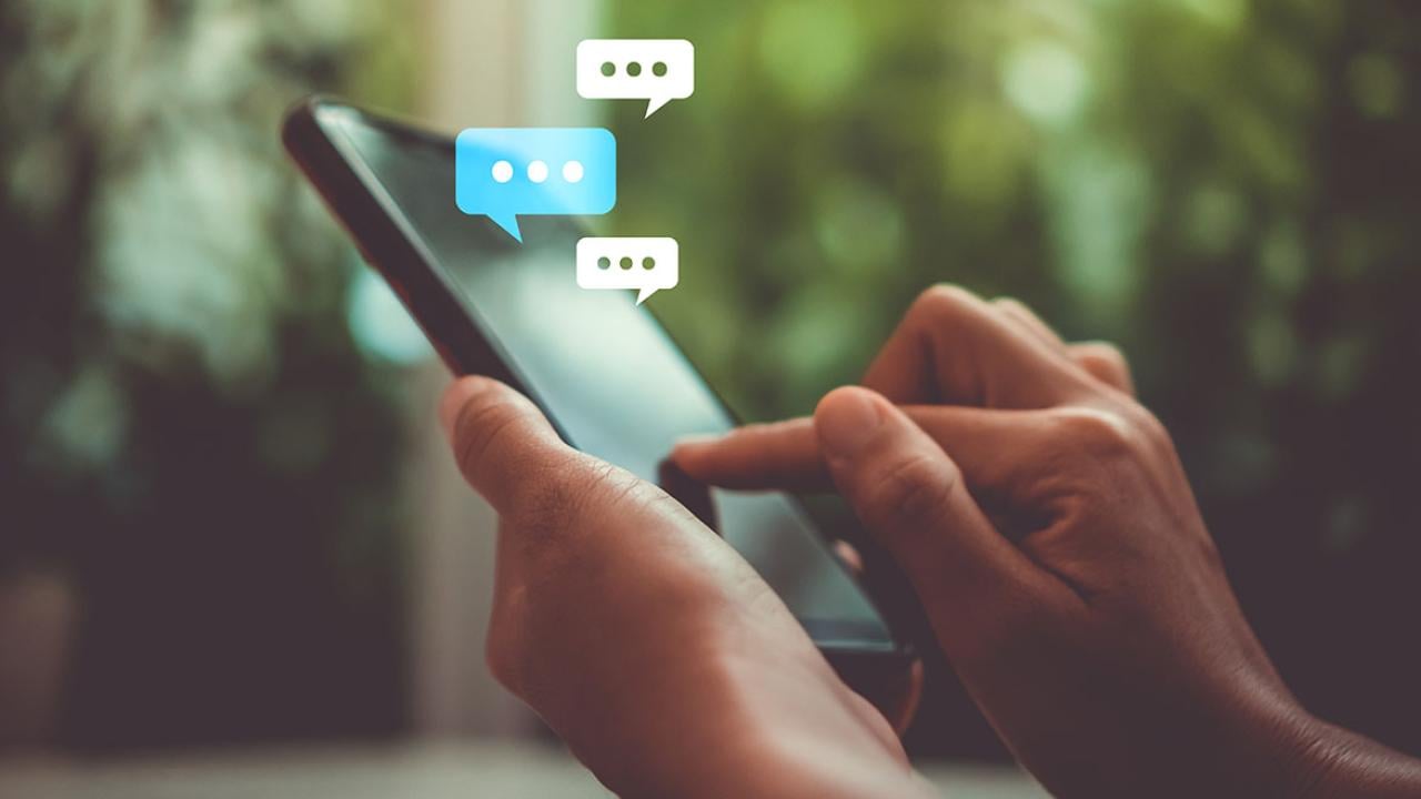 Person using mobile phone with speech bubbles
