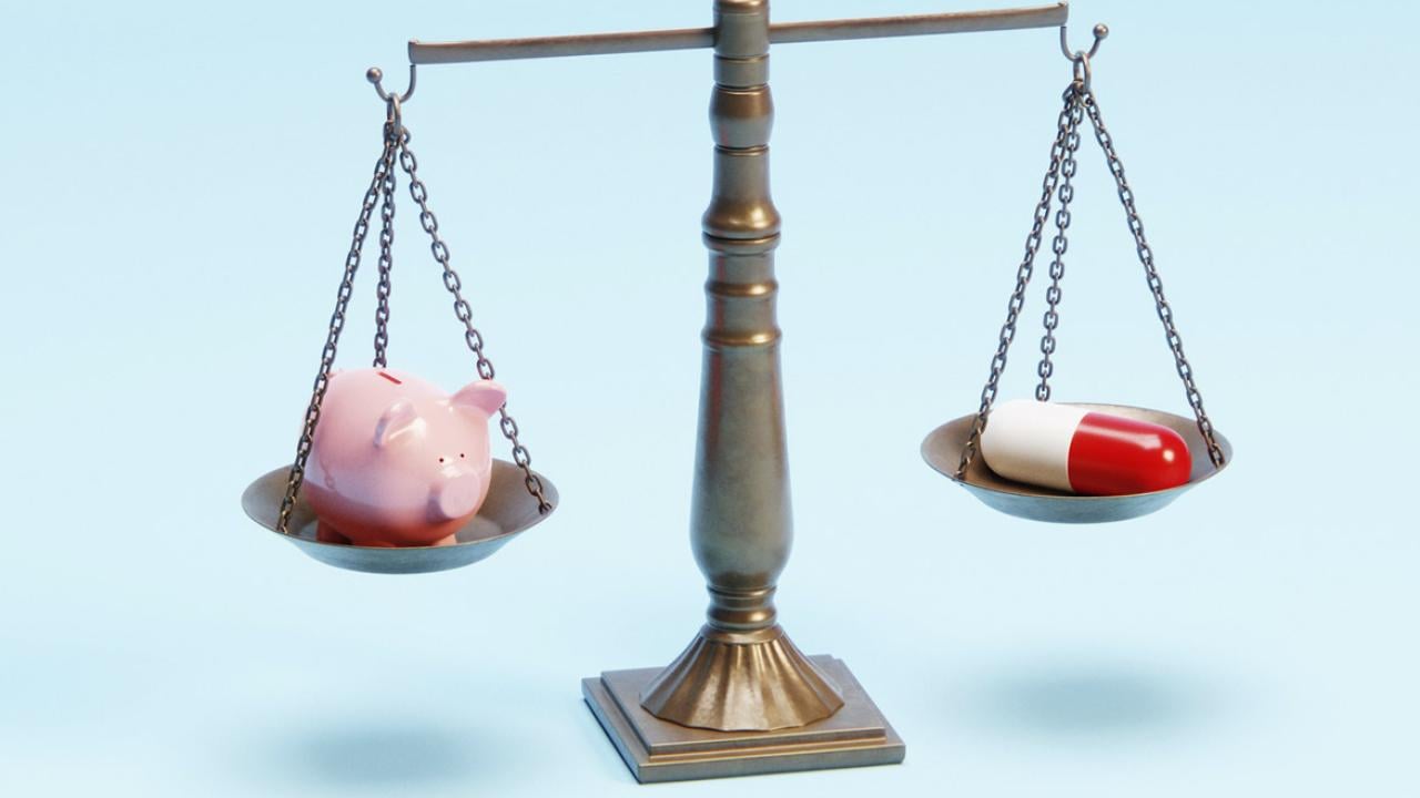Justice scale with a piggy bank and an oversized pharmaceutical pill 