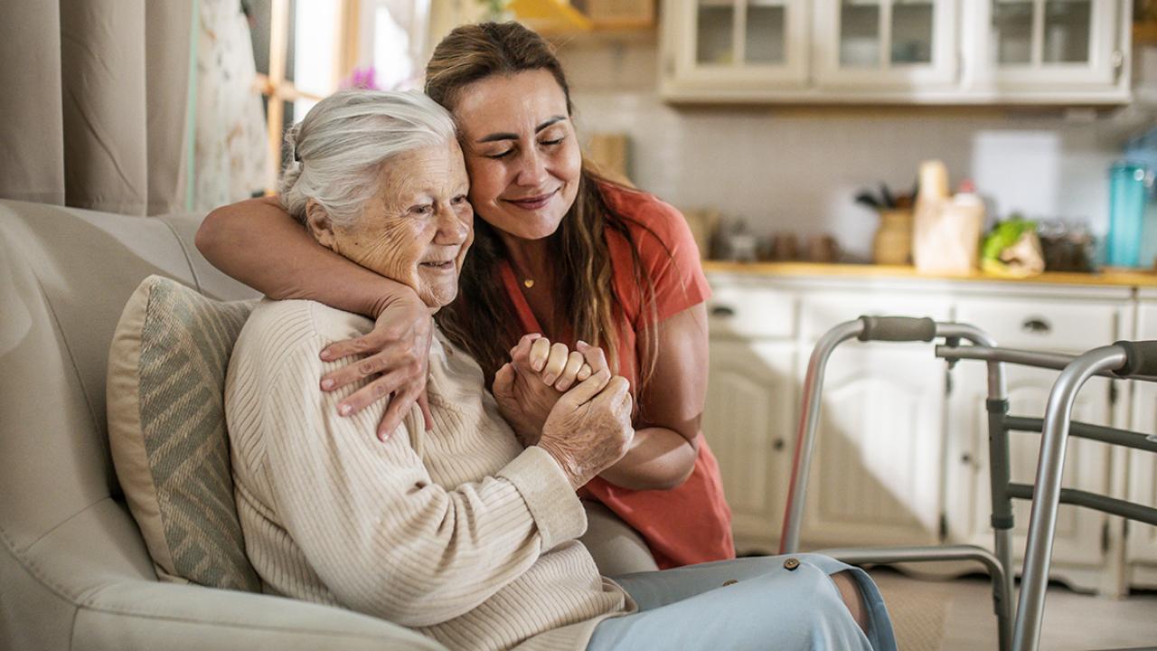Smiling woman embraces another