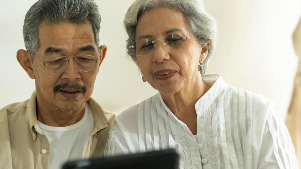 Couple looks at a tablet