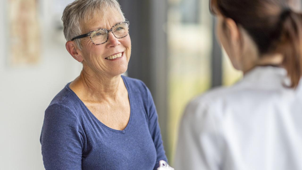Older adult speaks with physician