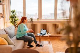 Person on a couch having a virtual meeting