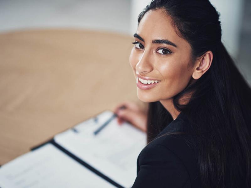 Woman looking up from reading a contract