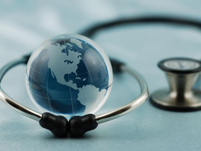 Image of stethoscope around a globe