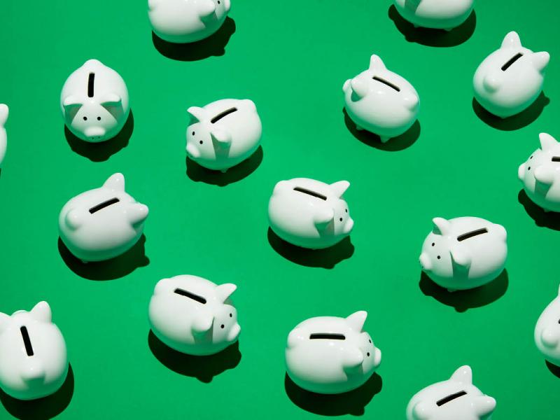White piggy banks on a green background