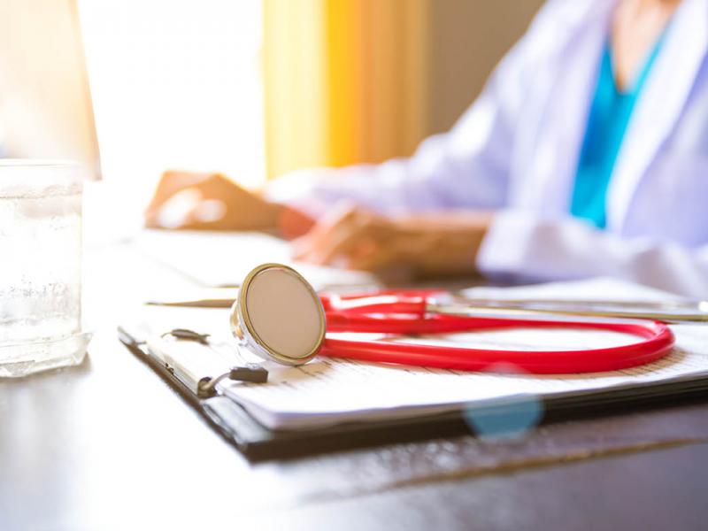 Stethoscope and notes next to a physician