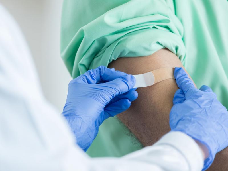 Health care worker applying a bandage