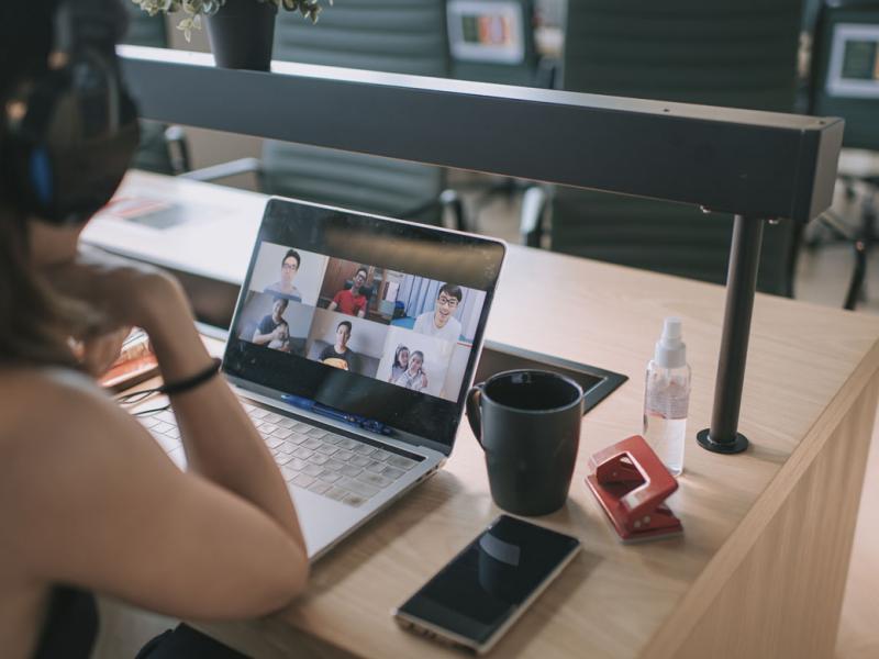 Person having a virtual meeting on a laptop
