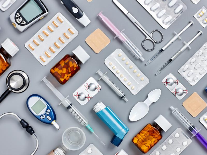 Variety of medications and medical instruments arranged in a patterned grid.