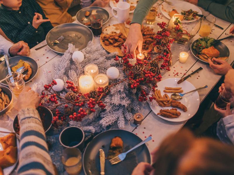 Family gathered around a dining room table for the holidays.
