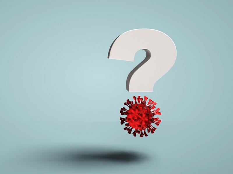 Question mark with illustration of COVID-19 virus floating in the air.