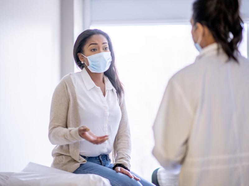 Physician and patient wearing face masks
