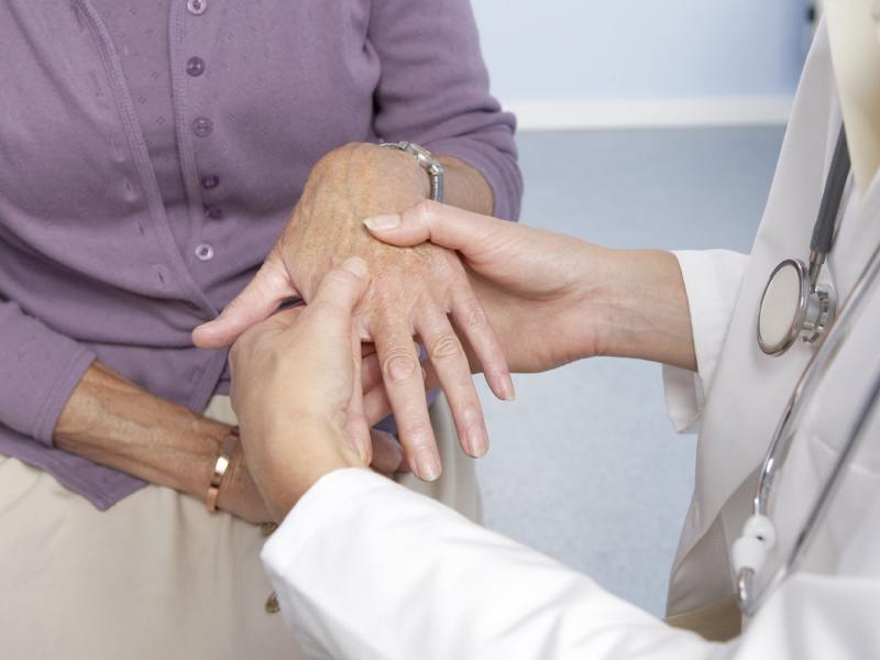 Physician examining a patient's hand