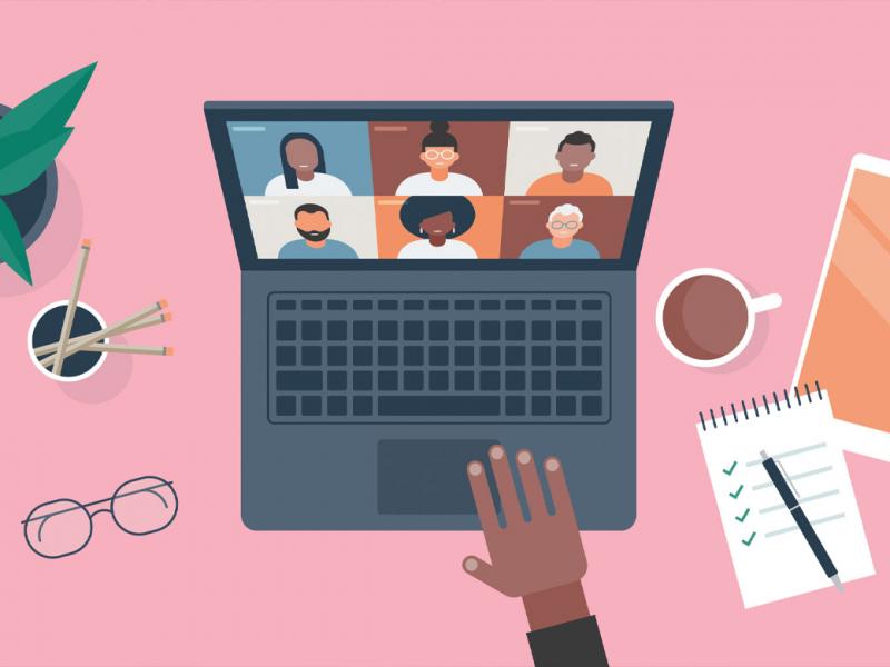 Person at desk using computer for video call 