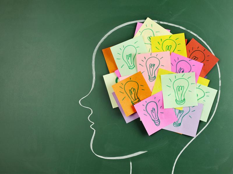 Chalkboard drawing of a head with post-it notes