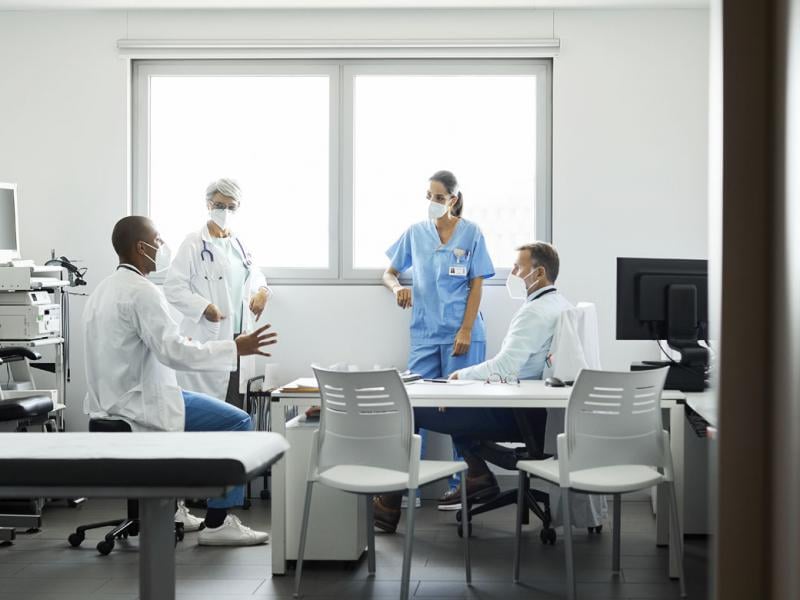 Physician care team discussing work