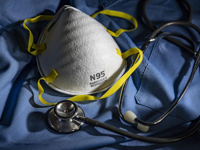 Face mask with stethoscope and scrubs