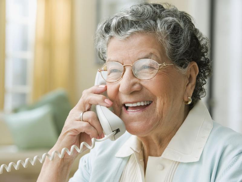 Smiling person speaking on the phone