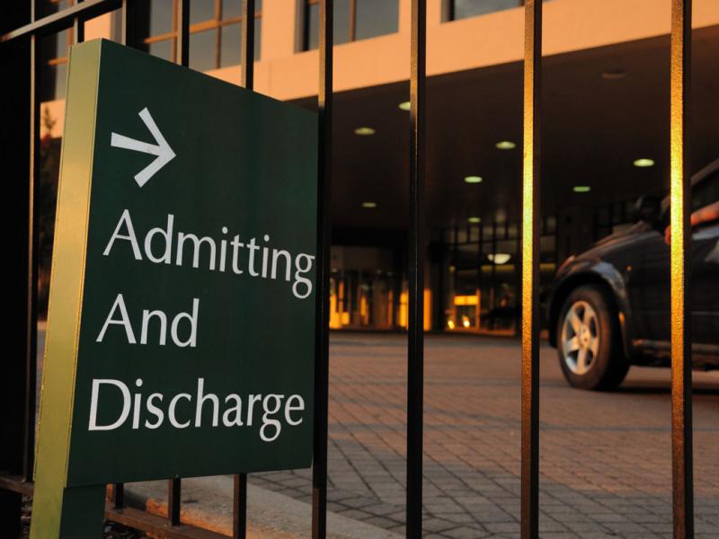 Sign outside of hospital with text indicating admitting and discharge of patients