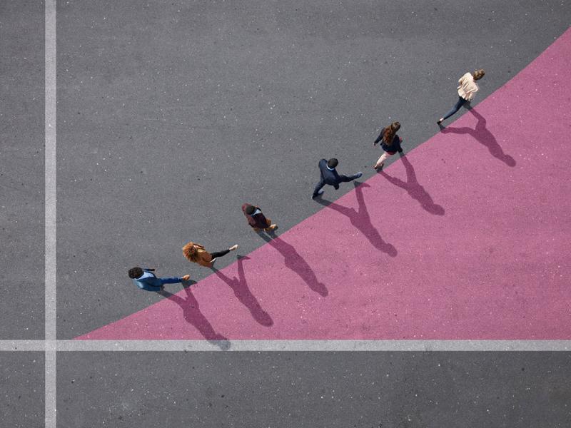 Group of people walking on painted tarmac surface