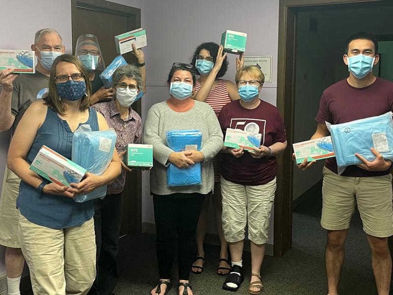 The Iowa City Free Medical Clinic employees holding PPE