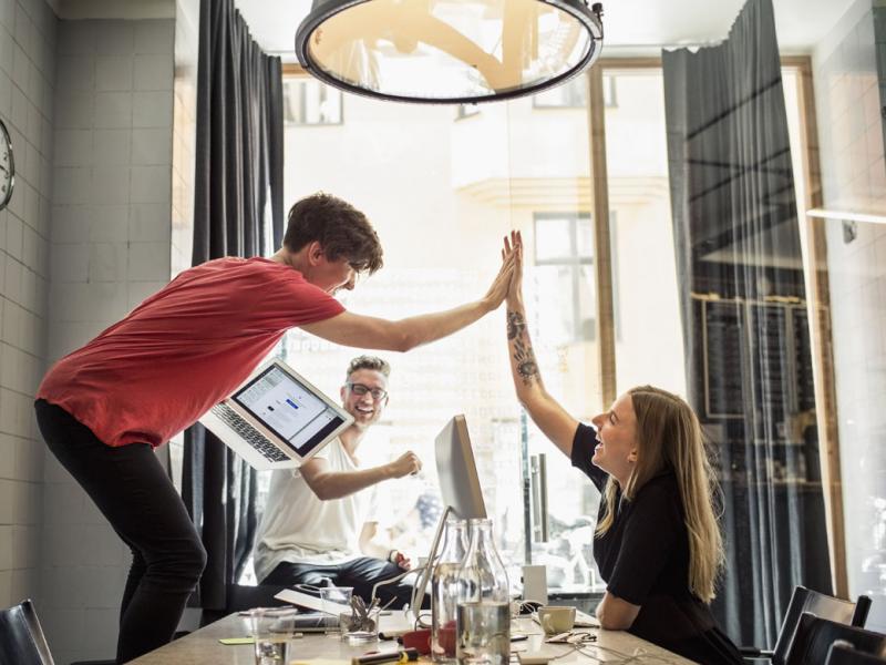 Two people giving one another a high five