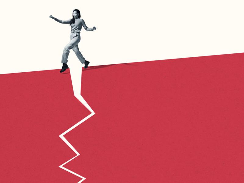 Person walking stealthily on broken red footpath 