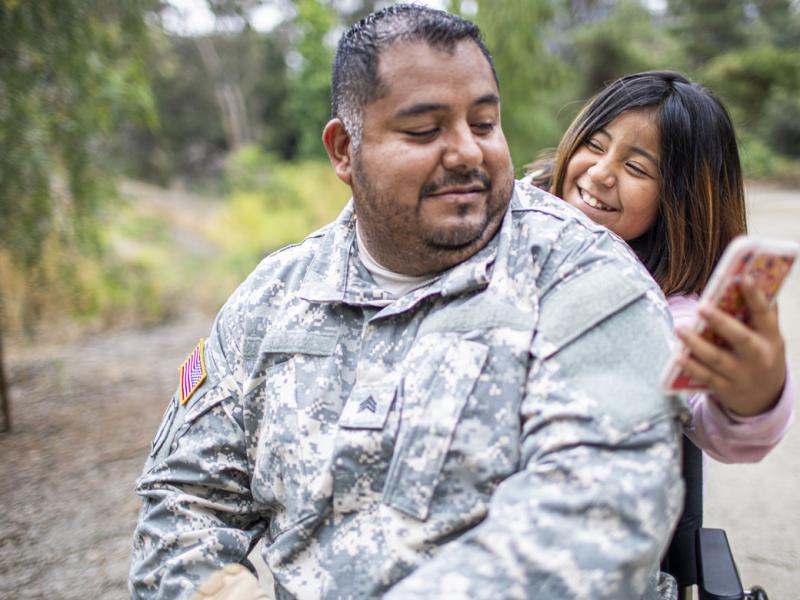 Smiling child showing a parent their smartphone
