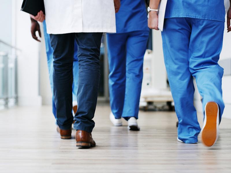 Health care workers walking down a hallway