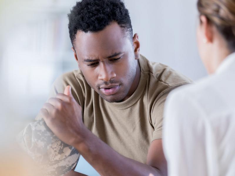 Military veteran speaking with another individual