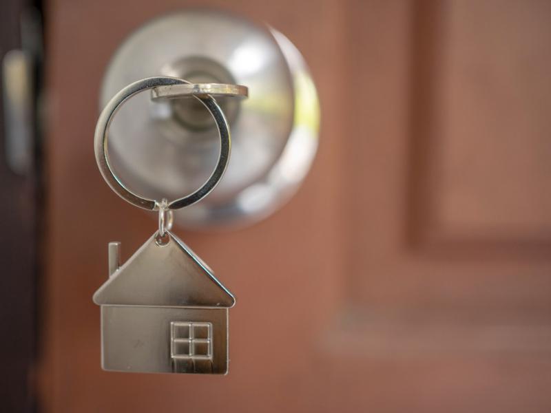 Door knob with key in the shape of a house