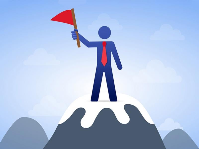 Illustration of a figure holding a red flag, and standing on top of a snow capped peak