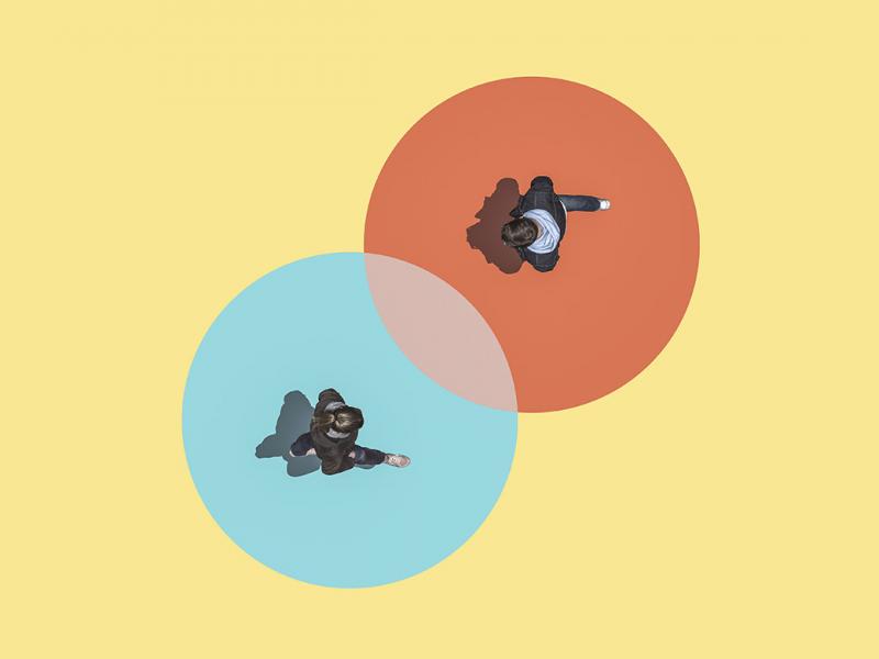 Aerial view of two people each standing in the middle of two circles.