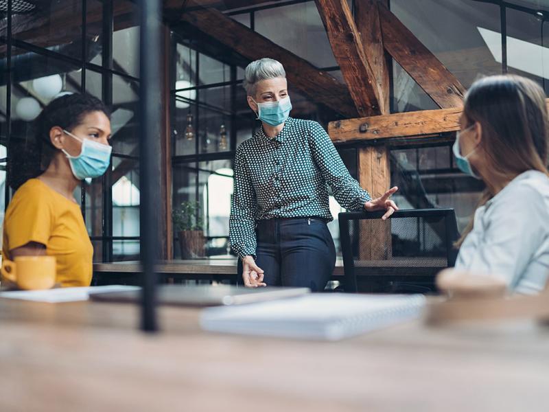 Three women having a meeting at an open office space