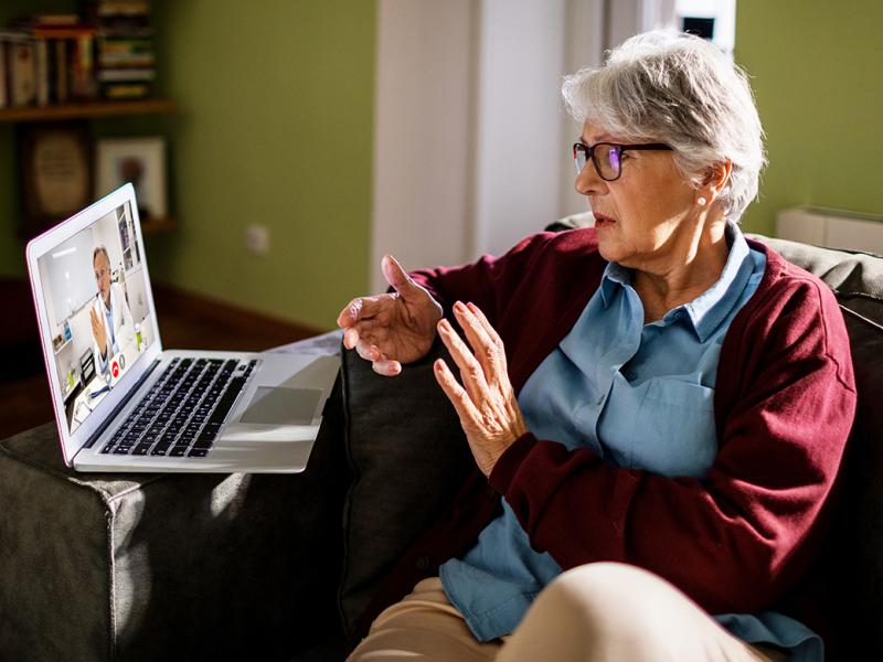 Older woman on a laptop having a virtual medical visit or telehealth appointment with a physician