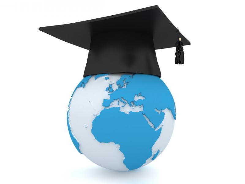 A globe of the world with a graduation cap placed on top