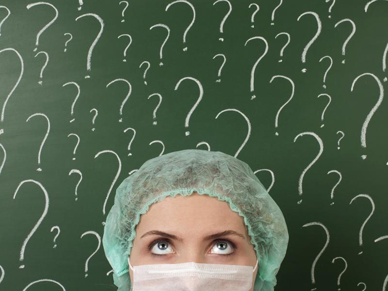 Person looking up at question marks