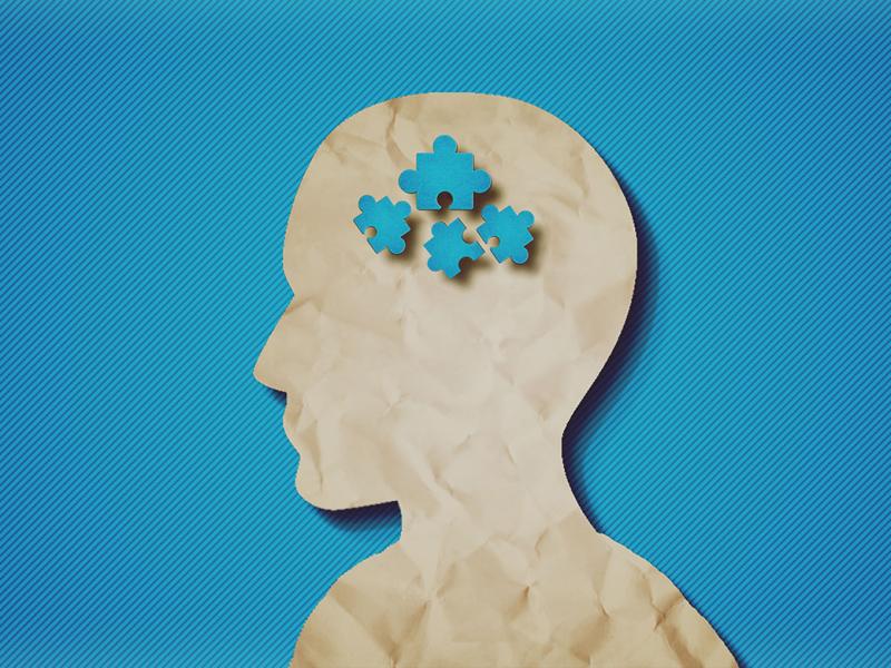 Profile of a paper head with puzzle pieces