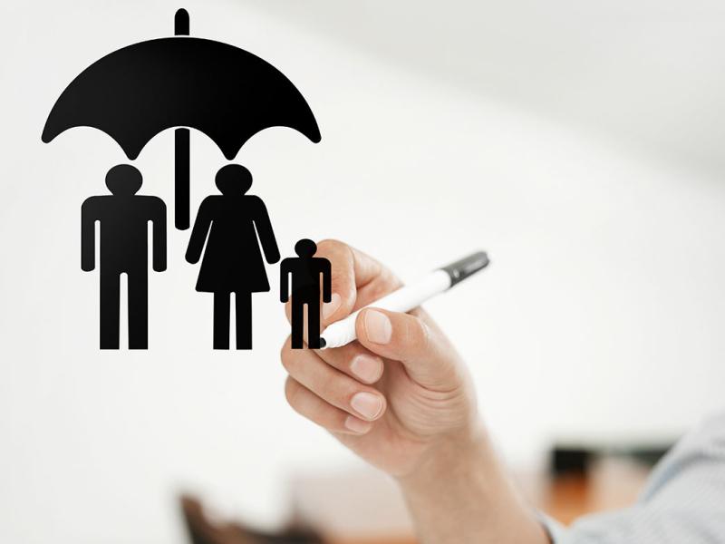 Three figures under an umbrella