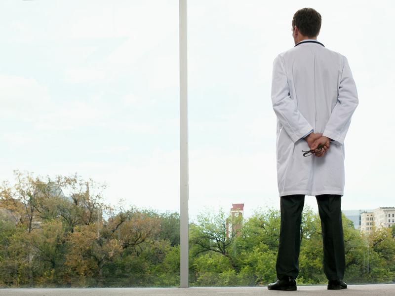 Physician looking out a window