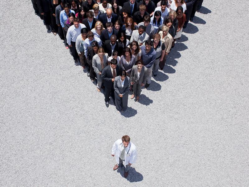 Group of people shaped in a triangle