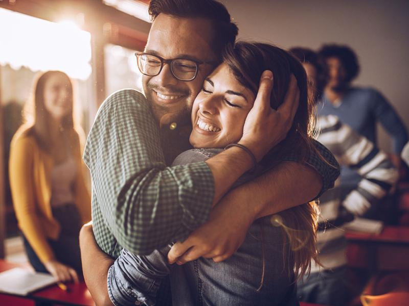 Smiling people in an embrace