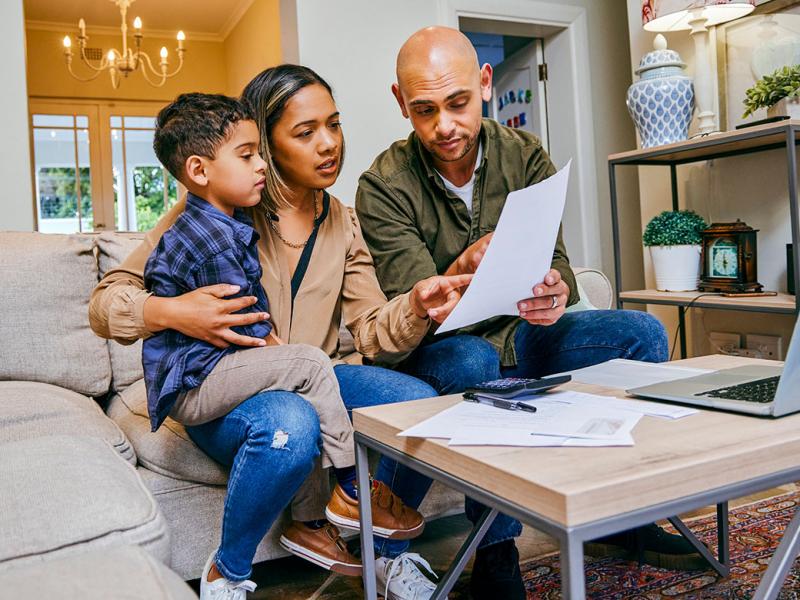 Family of three looking at a document