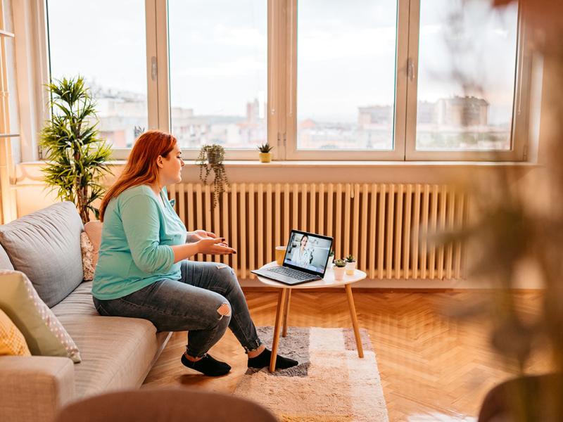 Person on a couch having a virtual meeting