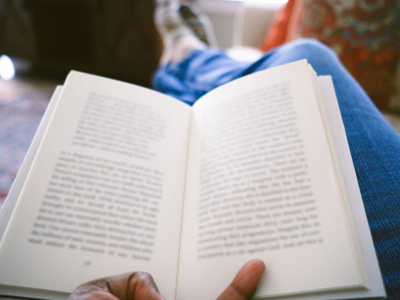 Hand holding an open book