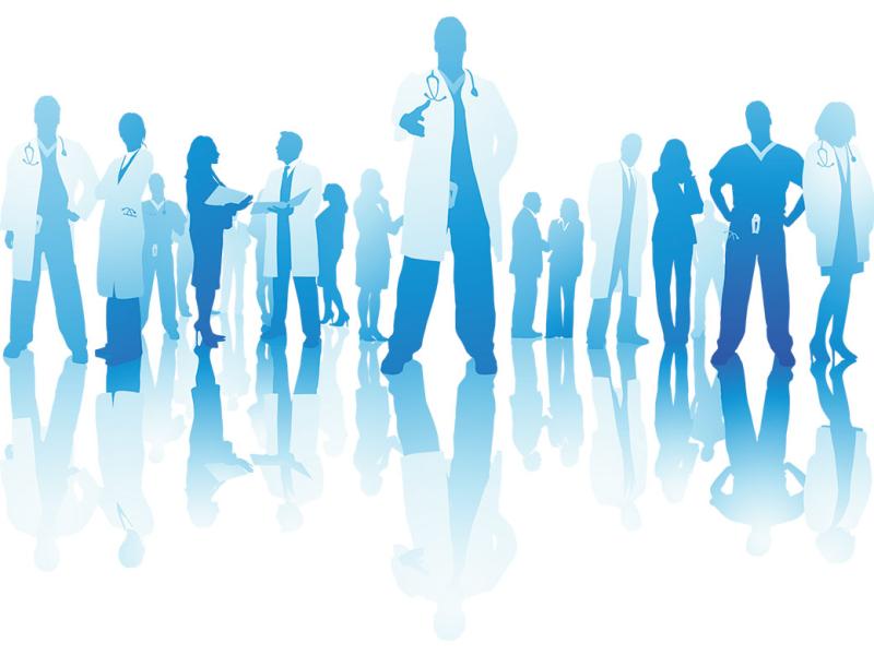  Silhouetted health care professionals with a central figure with hand outstretched