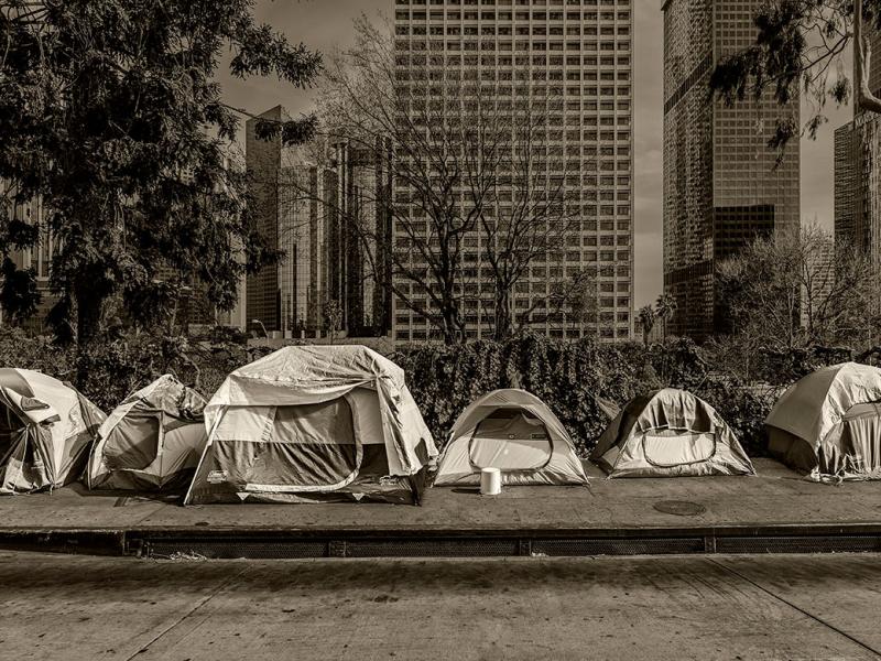 Homeless tents, skyscrapers in background 